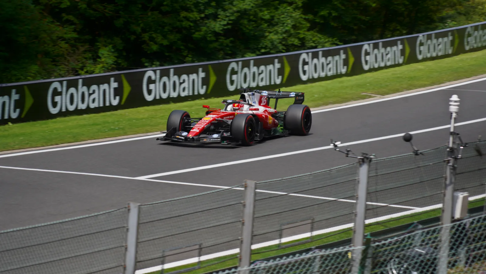 Charles Leclerc's red Ferrari SF-26 at high speed on a straight at Spa-Francorchamps