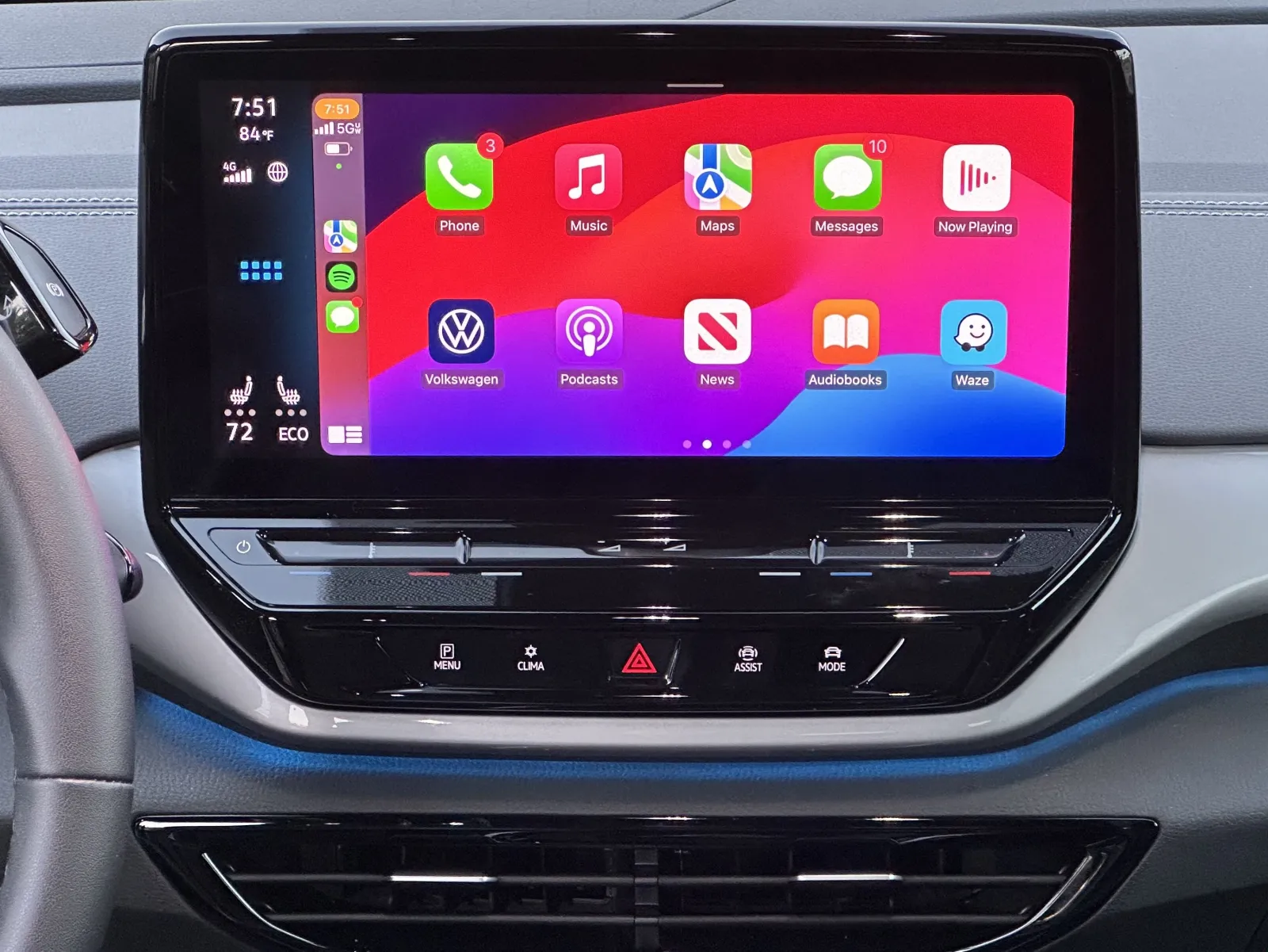 Modern electric car center dashboard display running Apple CarPlay wireless projection