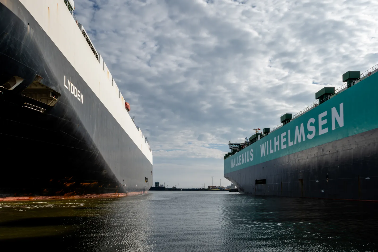 Two roll-on roll-off car carrier ships berthed at a European export port