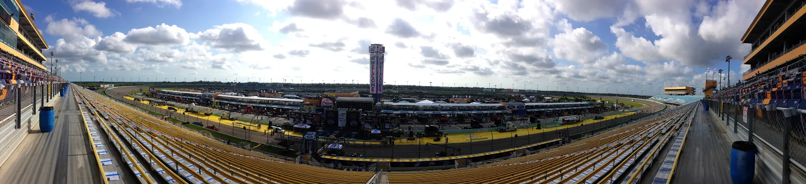 Panoramic view of Homestead-Miami Speedway grandstands, pit road and the banked oval