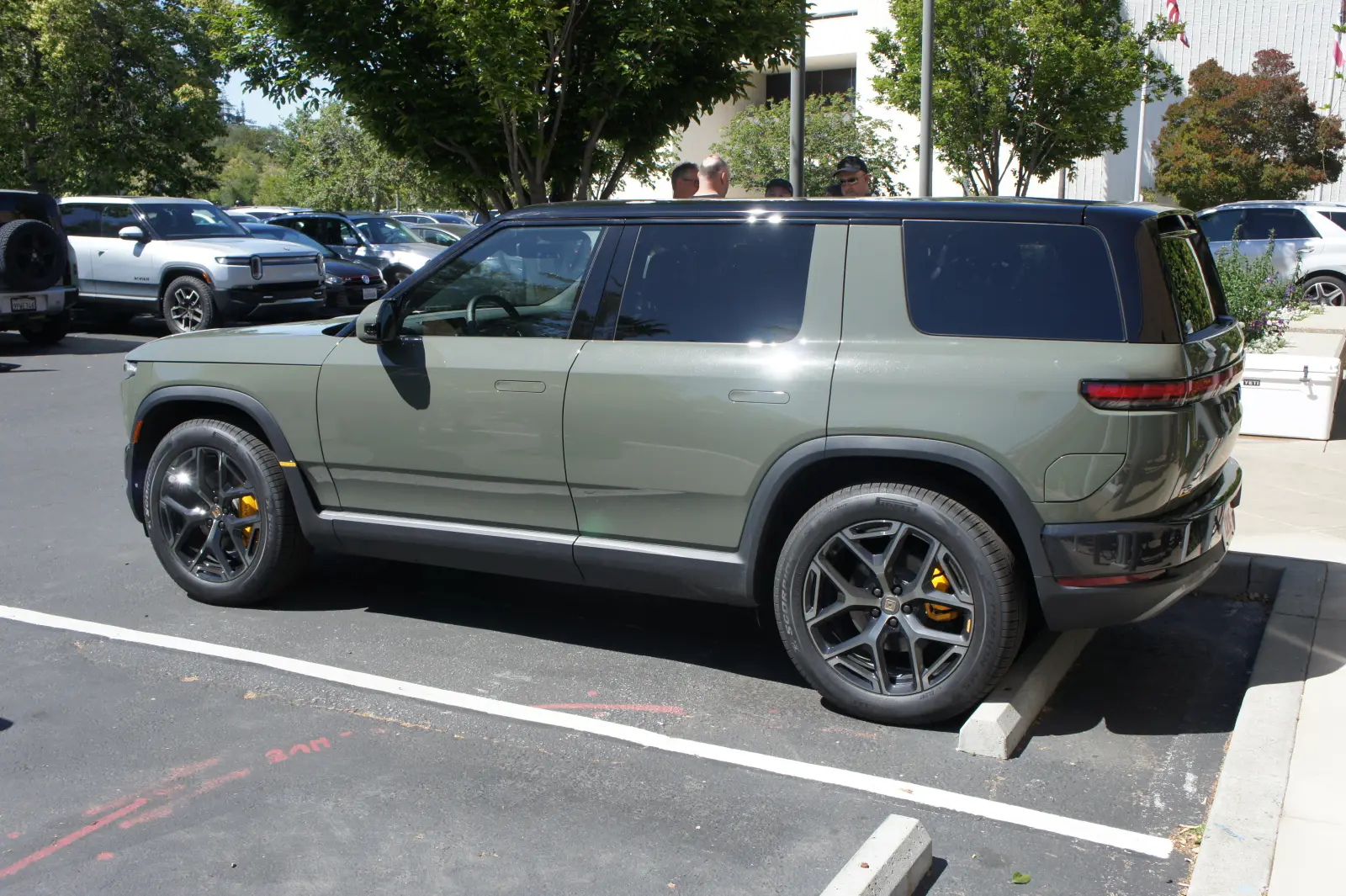 Side and rear view of a Rivian R2 showing its short overhangs and flat sides