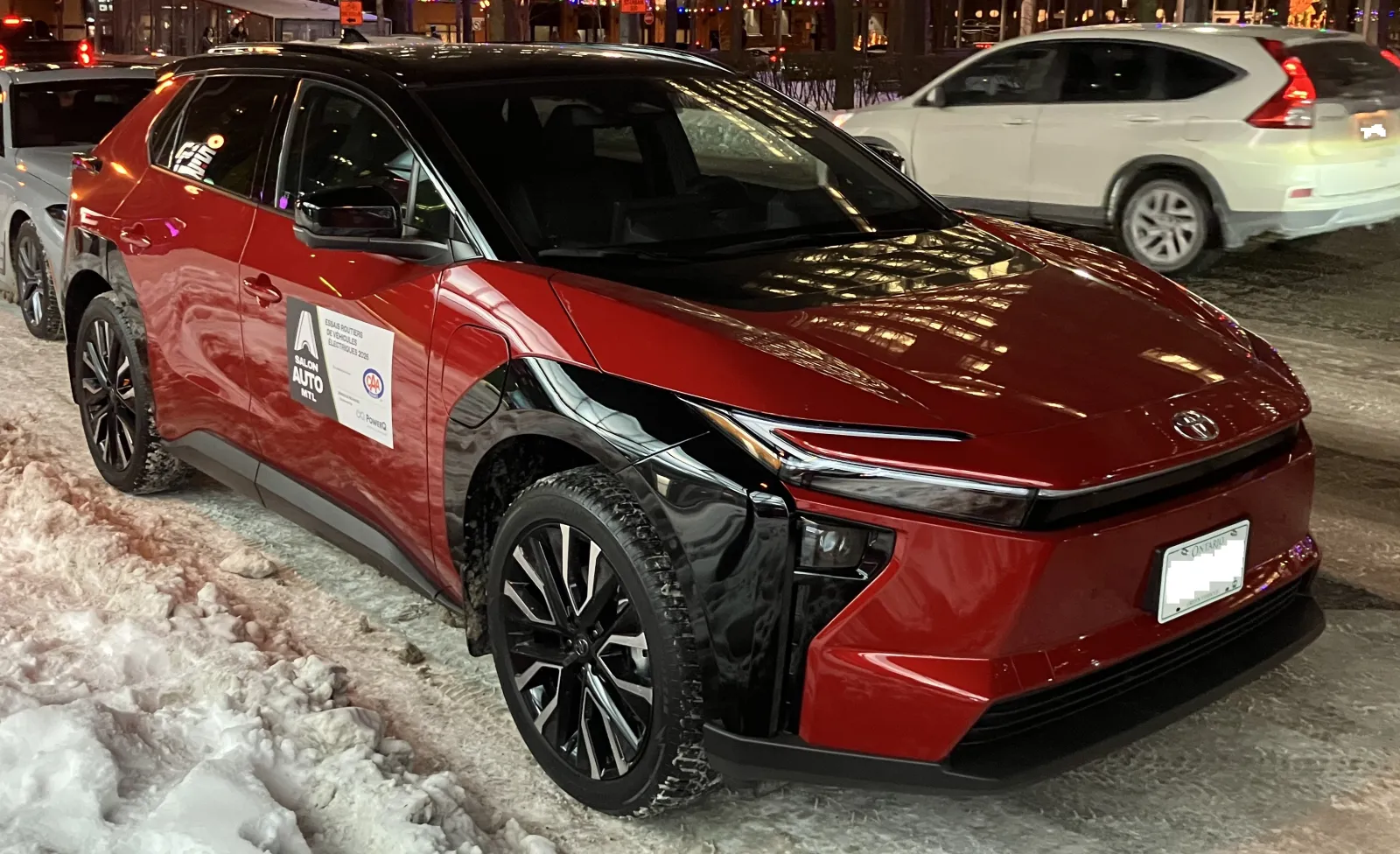 2027 Toyota bZ XLE vs Limited which to buy: red bZ parked in winter slush